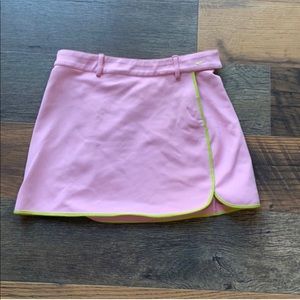 Pink mini Nike tennis skirt with green lining.
